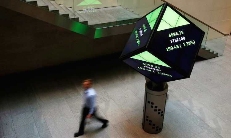 File photo of a man walking through the lobby of the London Stock Exchange in London